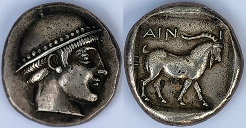 Ancient Greek silver tetradrachm coin from Ainos, Thrace, with head of Hermes facing right in a petasos on the obverse and a goat standing right with the inscription AINI on the reverse.