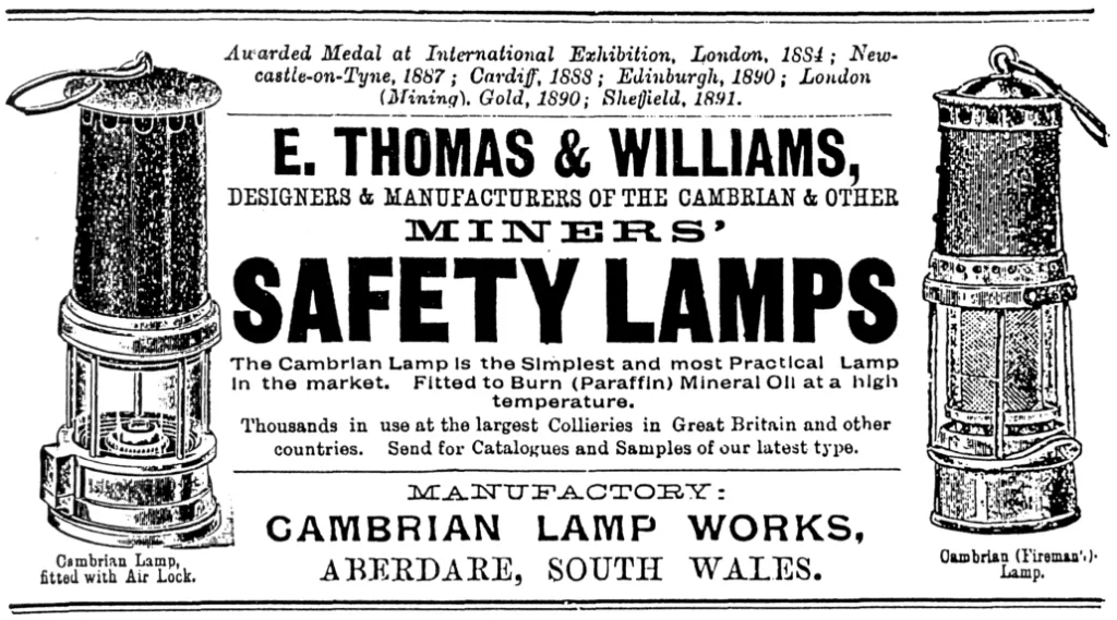 Anzeige von 1900 für die Cambrian-Sicherheitslampen von E. Thomas & Williams, mit Abbildungen von zwei Lampentypen (Air Lock und Fireman’s), Hinweisen auf internationale Auszeichnungen und der Herstellung in den Cambrian Lamp Works, Aberdare, Südwales.