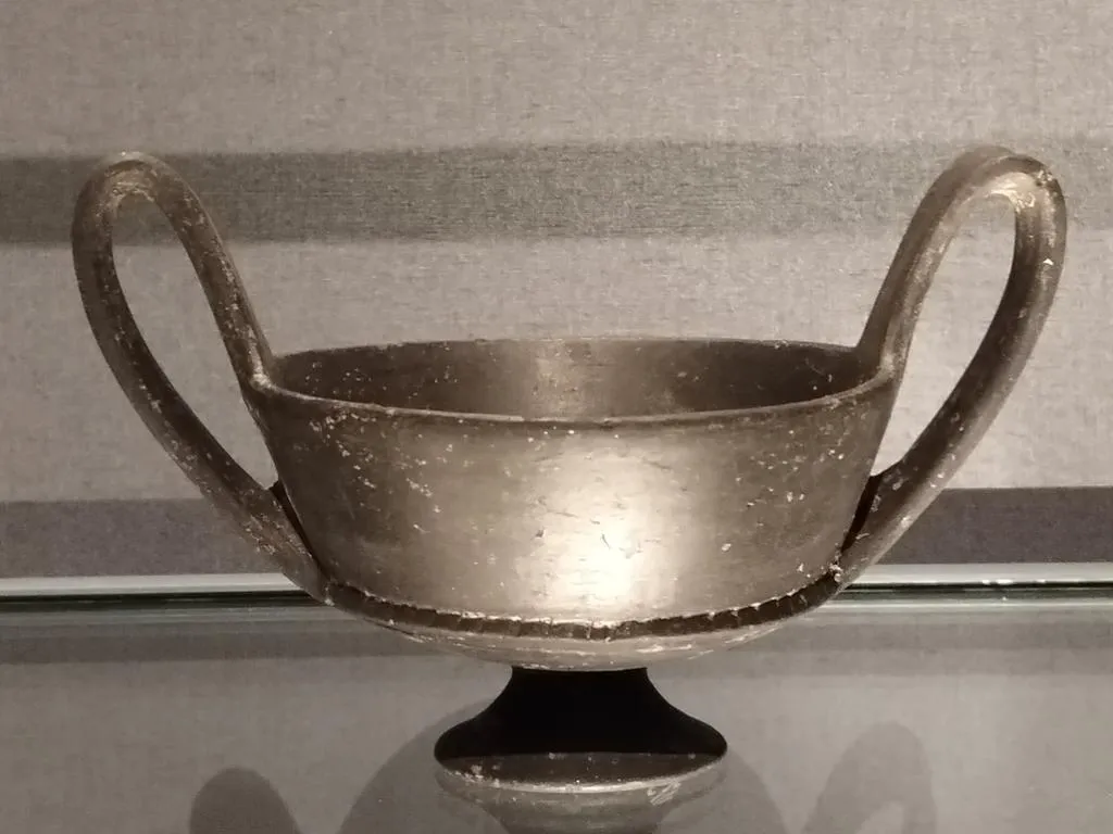 Etruscan kantharos with tall looping handles and black-glazed surface, from Caere, dated late 7th to early 6th century BC.