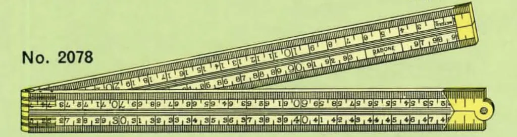 Close-up of a vintage Rabone No. 2078 folding boxwood rule with brass V-joint, showing dual scales in millimetres and inches in 8ths.