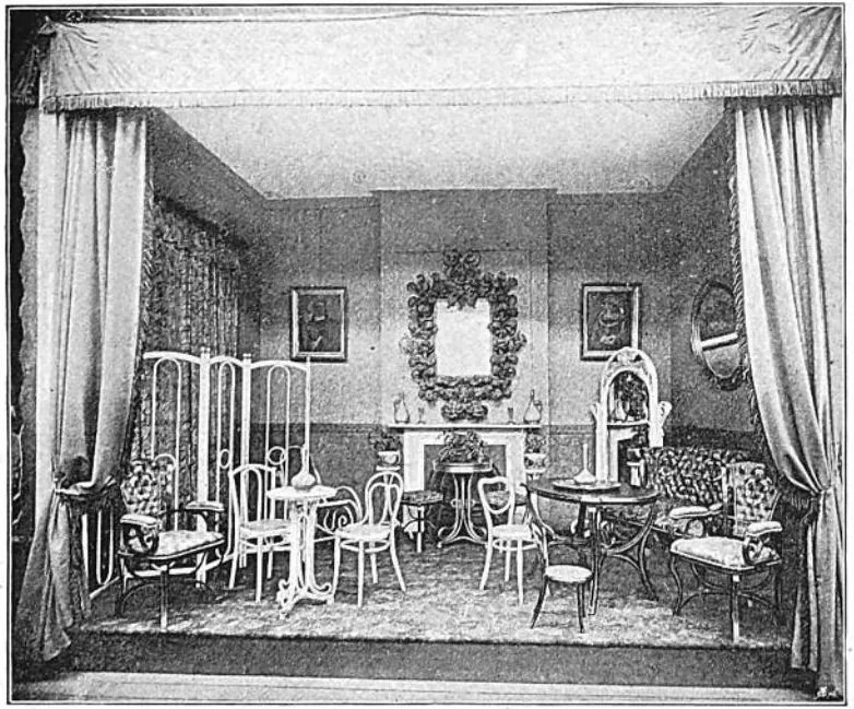 Black-and-white photograph of an exhibition interior showing bentwood chairs, tables, and furniture by Gebrüder Thonet, displayed with curtains, a fireplace, and decorative mirrors at the 1851 London World Exhibition.