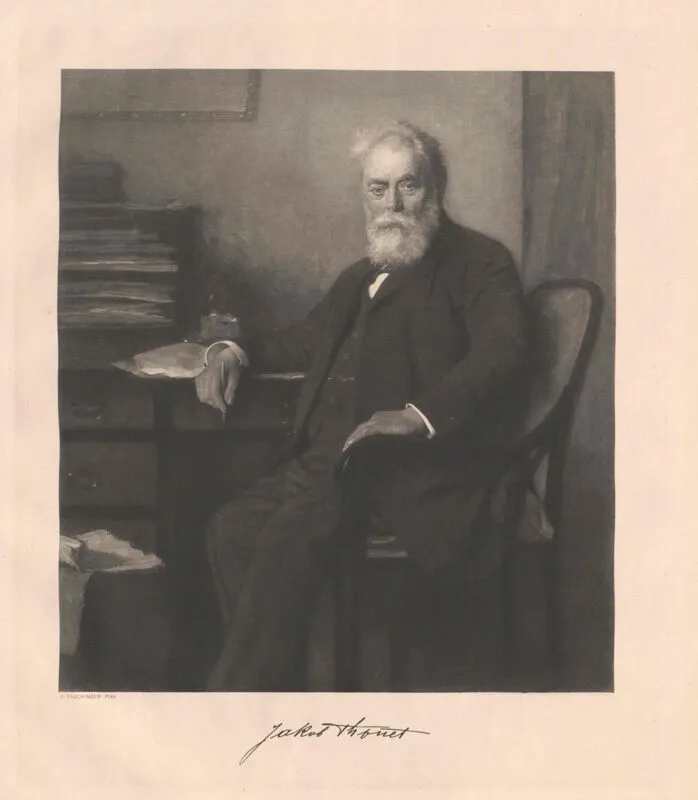 Black-and-white portrait of Jakob Thonet seated at a desk, wearing a dark suit with white beard, depicted in a formal 19th-century style.
