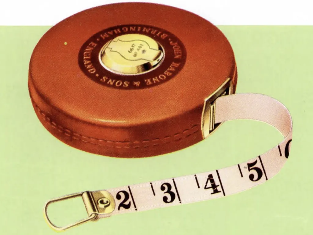 Close-up of a vintage Rabone metallic woven measuring tape in a round brown leather case with brass details, showing white tape with large black inch numbers.