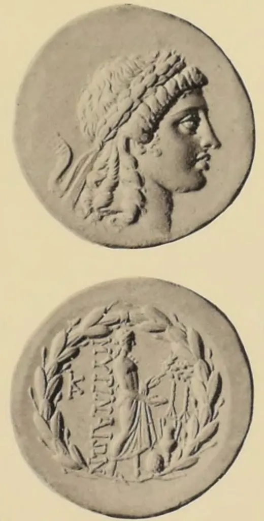 Ancient Greek silver tetradrachm coin from Myrina, Aeolis, with laureate head of Apollo right on the obverse and Apollo Gryneios standing right with phiale, branch, omphalos, amphora, monogram, and laurel wreath on the reverse.