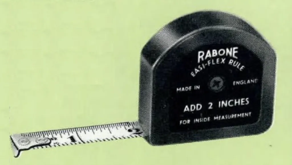 Black D-shaped Rabone “EASIFLEX” tape measure, No. 363, with 6 ft and 2 m blades. Features a ½-inch wide white blade, durable plastic case, and automatic 2-inch compensation for internal measurements. Marked in inches (8ths, 16ths, 32nds) and metric divisions.