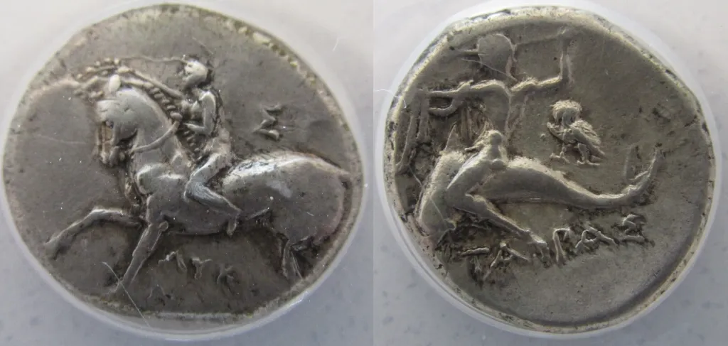 Ancient Greek silver didrachm of Taras in Calabria shown in two sides, with a helmeted young rider moving left with shield and spear on the obverse and Taras riding a dolphin left on the reverse, with trident, K below, and stylized waves.